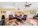 Open living room with vaulted ceilings, hardwood floors, comfortable seating, and ample space for an office setup at 3102 Cecelia Dr, Apopka, FL 32703