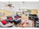 Spacious living room with vaulted ceilings, ceiling fans, multiple windows, hardwood floors, and ample seating at 3102 Cecelia Dr, Apopka, FL 32703