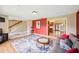 Open concept living room with access to the foyer, staircase, and kitchen at 3102 Cecelia Dr, Apopka, FL 32703