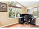 Bright home office featuring hardwood floors, a large window with blinds, and a desk setup for productivity at 3102 Cecelia Dr, Apopka, FL 32703