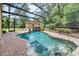 Enjoy this backyard screened-in pool, with a waterfall feature and brick paver patio at 3102 Cecelia Dr, Apopka, FL 32703