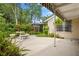 Backyard with mature landscaping, a table and benches, and a view of the house at 3223 N Orange Ave, Orlando, FL 32803