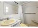 Full bathroom features a tiled shower with grab bar, seat, and sink at 3223 N Orange Ave, Orlando, FL 32803