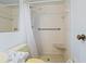 Full bathroom features a tiled shower with grab bar, seat, and fixtures at 3223 N Orange Ave, Orlando, FL 32803