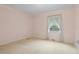 Bright bedroom with a large window and neutral carpet at 3223 N Orange Ave, Orlando, FL 32803