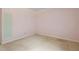 Simple bedroom with neutral carpet, light pink walls and minimal fixtures at 3223 N Orange Ave, Orlando, FL 32803