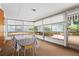 Bright dining area features many windows, a table and chairs, and neutral carpet at 3223 N Orange Ave, Orlando, FL 32803