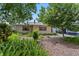 Inviting home with mature trees, lush ferns, and a cozy pergola entrance at 3223 N Orange Ave, Orlando, FL 32803