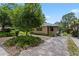Charming home featuring a stone-paved driveway, lush landscaping, and a welcoming entrance at 3223 N Orange Ave, Orlando, FL 32803