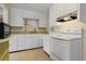 Bright kitchen features white cabinets, appliances, and a tile floor at 3223 N Orange Ave, Orlando, FL 32803