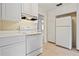 Bright kitchen features white cabinets, appliances, and a tile floor at 3223 N Orange Ave, Orlando, FL 32803