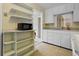 Bright kitchen features white cabinets, appliances, and a tile floor at 3223 N Orange Ave, Orlando, FL 32803