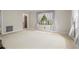 Spacious living room with large windows, neutral walls, and an open doorway at 3223 N Orange Ave, Orlando, FL 32803