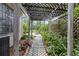 Charming walkway with a pergola and lush greenery, leading to a peaceful outdoor seating area at 3223 N Orange Ave, Orlando, FL 32803