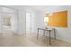 Clean room features neutral flooring, a corkboard, a utility table, and white walls at 3223 N Orange Ave, Orlando, FL 32803