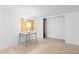 Clean room features neutral flooring, a corkboard, a utility table, and white walls at 3223 N Orange Ave, Orlando, FL 32803