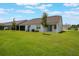 Expansive backyard shows a well maintained lawn with a covered patio at 3240 Canna Lily Pl, Clermont, FL 34711
