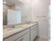 Bathroom featuring double sink vanity, granite countertops, and tiled floors at 3240 Canna Lily Pl, Clermont, FL 34711