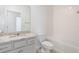 Modern bathroom features white cabinetry, granite countertop, and a tiled shower/tub combo at 3240 Canna Lily Pl, Clermont, FL 34711
