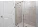 Modern bathroom with glass door shower, tile surround, and neutral tones at 3240 Canna Lily Pl, Clermont, FL 34711