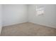 Carpeted bedroom features neutral tones and a window at 3240 Canna Lily Pl, Clermont, FL 34711