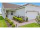 Inviting single-story home with a well-maintained lawn, manicured landscaping, and an attached two-car garage at 3240 Canna Lily Pl, Clermont, FL 34711