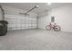Epoxy-coated garage with attached bike, and trash can at 3240 Canna Lily Pl, Clermont, FL 34711
