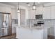 Bright kitchen featuring white cabinets, granite countertops, stainless steel appliances, and pendant lighting at 3240 Canna Lily Pl, Clermont, FL 34711