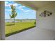 Covered patio view overlooking lush green lawn and beautiful lake view at 3240 Canna Lily Pl, Clermont, FL 34711