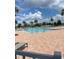 Community pool with brick surround and many lounge chairs at 3240 Canna Lily Pl, Clermont, FL 34711