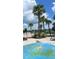 Gathering-friendly splash pad with palm trees and lounge chairs at 3240 Canna Lily Pl, Clermont, FL 34711