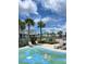 Community splash pad with surrounding palm trees and lounge chairs at 3240 Canna Lily Pl, Clermont, FL 34711