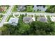 An aerial view of upscale homes with backyard pools, manicured lawns, and a serene lake with a fountain feature at 343 Leslie Ln, Lake Mary, FL 32746