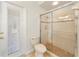 Bathroom with tiled shower, toilet and exterior door at 343 Leslie Ln, Lake Mary, FL 32746