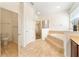 Well-lit bathroom showcasing a tiled garden tub, glass-enclosed shower, and adjacent toilet room at 343 Leslie Ln, Lake Mary, FL 32746