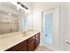 Bathroom featuring a tiled shower, sink with wood cabinets, and an exterior access door at 343 Leslie Ln, Lake Mary, FL 32746