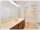 Bright bathroom with a wide mirror over a cream countertop, and a tub shower combo with tile surround at 343 Leslie Ln, Lake Mary, FL 32746