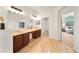 Elegant bathroom featuring double sinks, wood cabinetry, tile flooring, and access to a bedroom and closet at 343 Leslie Ln, Lake Mary, FL 32746