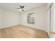 A bright bedroom with laminate floors, ceiling fan, and a window with blinds at 343 Leslie Ln, Lake Mary, FL 32746