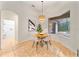 Cozy dining area with a round table, four chairs, a pendant light, and views of the backyard and pool at 343 Leslie Ln, Lake Mary, FL 32746