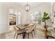 Bright dining room with a wooden table and modern white chairs at 343 Leslie Ln, Lake Mary, FL 32746