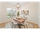 Elegant dining room with modern chandelier and large windows at 343 Leslie Ln, Lake Mary, FL 32746