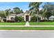 Charming single-story home with a well-manicured lawn and mature trees, and tan exterior at 343 Leslie Ln, Lake Mary, FL 32746