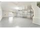Spacious three-car garage featuring epoxy flooring, ample storage, and a window at 343 Leslie Ln, Lake Mary, FL 32746