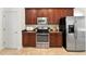Well-equipped kitchen with stainless steel appliances, microwave, oven, and refrigerator with brown wooden cabinets at 343 Leslie Ln, Lake Mary, FL 32746