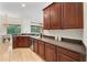 This kitchen area features wooden cabinetry, a built-in stainless steel dishwasher, and a dining area with views at 343 Leslie Ln, Lake Mary, FL 32746