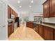 Spacious kitchen features wood cabinetry, stainless steel appliances, and breakfast nook with backyard views at 343 Leslie Ln, Lake Mary, FL 32746