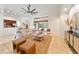 Bright living room features a ceiling fan and sliding glass doors leading to a screened-in patio and pool area at 343 Leslie Ln, Lake Mary, FL 32746