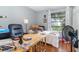 Functional bedroom featuring a daybed, a study area, wooden floors, and natural light at 3887 Atrium Dr # 3, Orlando, FL 32822