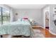 Cozy bedroom with a large window, hardwood floors, and soothing colors provides a relaxing retreat at 3887 Atrium Dr # 3, Orlando, FL 32822